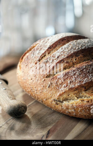 Fresh crusty Loaf of bread on wooden table Stock Photo