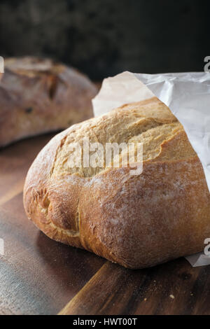 Loaf of wheat bread in paper bag Stock Photo