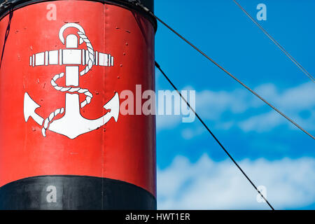 Old ship funnel with anchor sign in foreground and summer sky in background. Stockholm, Sweden, Scandinavia, Europe. Stock Photo