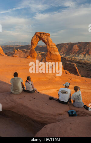 Tourists watching the sunset at the Delicate Arch, part of Arches National Park near Moab, Utah, United States Stock Photo