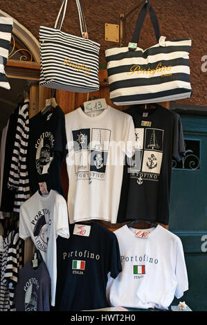 Italy: t-shirts and bags hanging outside of a gift shop in Piazzetta, the little square of Portofino, a famous Italian fishing village Stock Photo