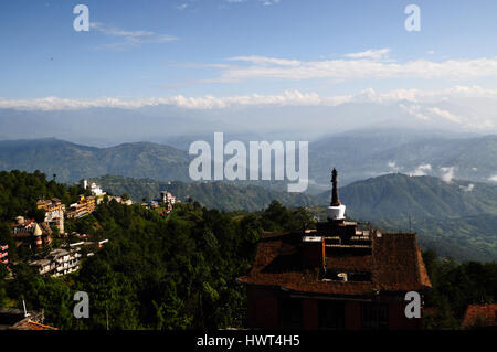 Roof top view on nepalese himalayas and hotel with stupa (mortar) on it - morning in nagarkot Stock Photo