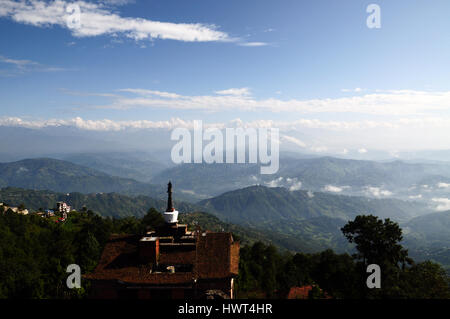 Roof top view on nepalese himalayas and hotel with stupa (mortar) on it - morning in nagarkot Stock Photo