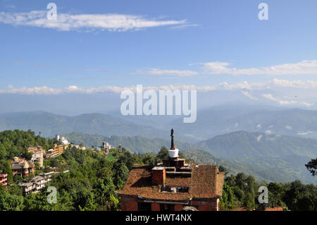 Roof top view on nepalese himalayas and hotel with stupa (mortar) on it - morning in nagarkot Stock Photo