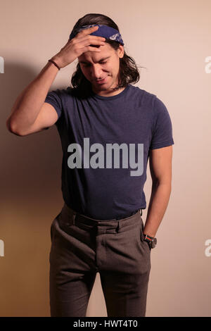 Young man rocker in bandana with long hair. Stock Photo