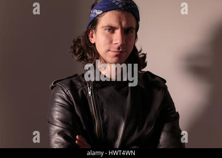 Young man rocker in bandana with long hair Stock Photo - Alamy