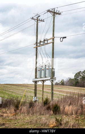 Three Electric Utility Transformers On Telephone Poles Stock Photo
