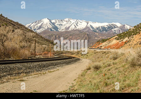 Nice S-curve in the railroad tracks as they head toward the mountains Stock Photo