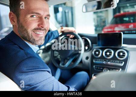 Customer trying out brand new car Stock Photo