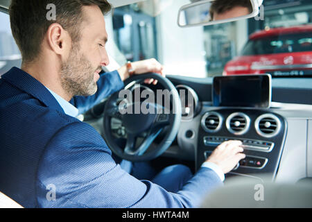 Handsome customer checking the car interior Stock Photo