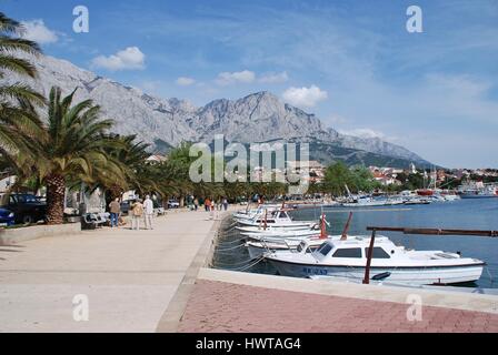 Small boats moored in the harbour at Baska Voda in Croatia. The Biokovo mountains are in the background. Stock Photo