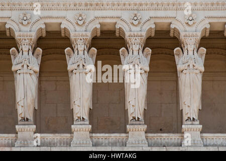 telamons in shape of angels on the facade of notre dame de fourviere Stock Photo