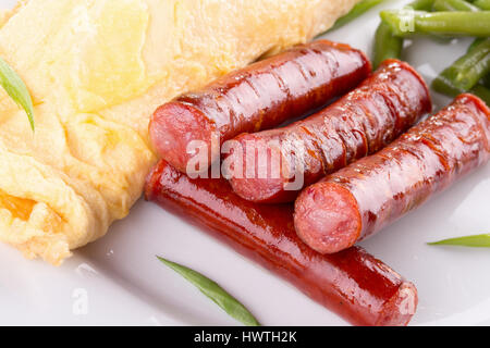 breakfast with omelet, asparagus and sausages. Stock Photo