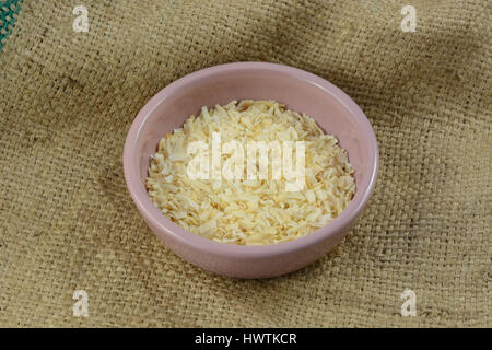 Dried onion flakes seasoning in small condiment bowl on burlap Stock Photo
