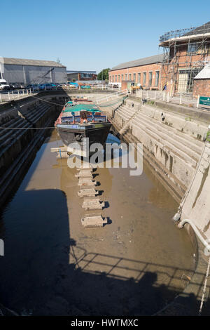 Unpowered barge Sabrina 5 in Gloucester drydock for repairs and restoration. Stock Photo