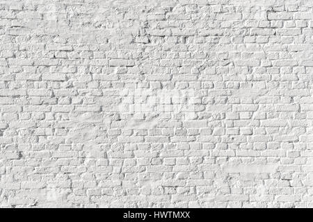 White painted uneven brick wall background Stock Photo