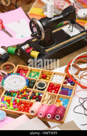 sewing machine and set of accessories to embroidery, haberdashery, sewing accessories top view, seamstress workplace, many object for needlework, hand Stock Photo