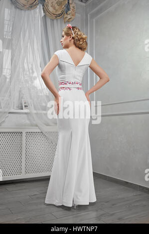 Elegant, beautiful, fashionable woman blonde in a long white dre Stock Photo