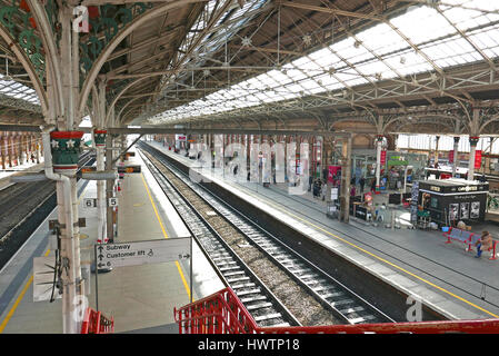 Passengers waiting for a intercity train on platform four of Preston railway station Stock Photo