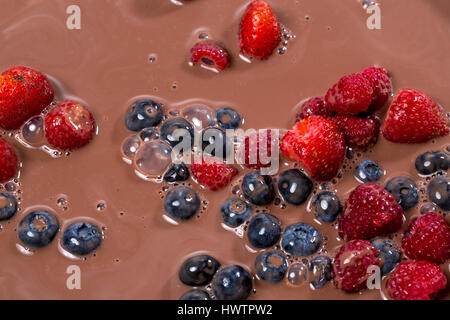 muesli and fresh berries and fruits with chocolate milk background Stock Photo