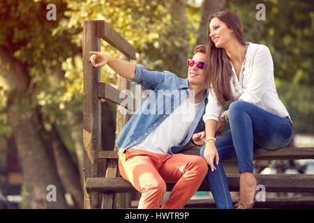 Young modern stylish couple rest in city park Stock Photo