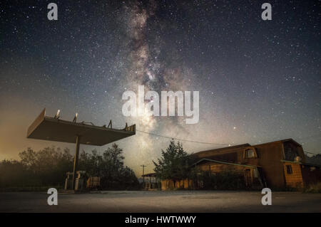 An abandoned roadside service station stands against the starlit sky and the milky way.  Canaan Valley, West Virginia. Stock Photo