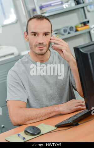Employee using his mobile phone Stock Photo