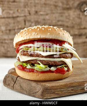 fresh tasty burger on wooden cutting board Stock Photo