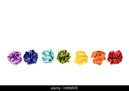 Crumpled colorful paper balls isolated on white. Colors of rainbow, chakras. Copy space Stock Photo