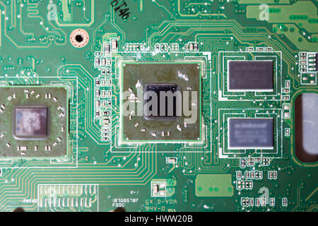 Close-up of electronic circuit board with chips and processors, motherboard laptop computer motherboard, CPU and graphics card scheme of electronic co Stock Photo