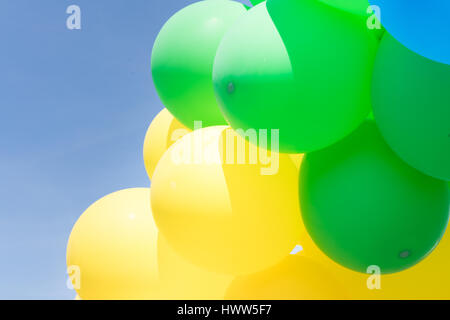 Multi colour balloons in a bunch floating in the sky Stock Photo