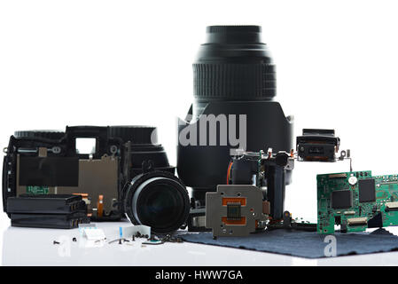 Disassembled modern photo camera parts isolated on white background. Repair DSLR service Stock Photo