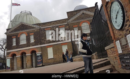 London, UK. 23rd Mar, 2017. A tourist reads a plaque on a wall by Royal Observatory as the Union Jack flag flies at half mast on March 23, 2017. Flags were hoisted at half-mast following the terror attack in Westminster on 22 March where four people lost their lives. Credit: David Mbiyu/Alamy Live News Stock Photo