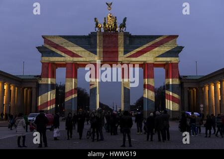 Berlin, Germany. 23rd Mar, 2017. People in font of the illuminated Brandenburg Gate which was lit up with the colors of the Union Jack one day after a terrorist attack in London, where at least four people were killed. Several pedestrians struck by a car on Westminster bridge, a police officer was stabbed in the Houses of Parliament by an attacker, who was shot by police. Credit: Jan Scheunert/ZUMA Wire/Alamy Live News Stock Photo