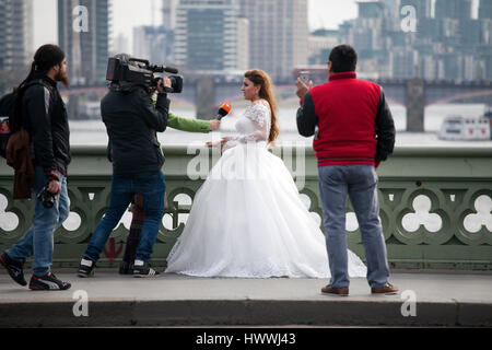 London, UK Thursday March 23, 2017 The bride is giving an interview on the bridge near Westminster. After the terrorist attack. Credit: Elena Rostunova/Alamy Live News Stock Photo