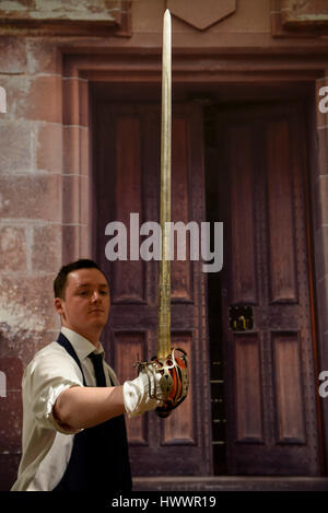 London, UK.  24 March 2017.  A technician examines a Scottish basket-hilted broadsword, said to be that carried by Alexander, 4th Lord Forbes of Pitsligo (Est. GBP1,200-1,500).  The inscription near the hilt reads 'Prosperity to SchotLand and no union'.  Preview at Sotheby's New Bond Street of property from two great Scottish families, the Forbeses of Pitsligo and the Marquesses of Lothian, which will be auctioned in London on 28 March.  Credit: Stephen Chung / Alamy Live News Stock Photo