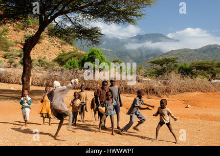 SOUTH HORR, KENYA - JULY 07: African children playing in a dry river bed in the vicinity of their village in Kenya, South Horr in July 07, 2013 Stock Photo