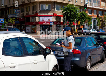Female traffic warden issuing a parking ticket in Santander Cantabria Spain Stock Photo