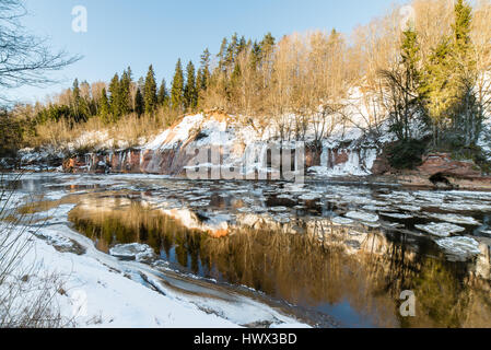 frozen river in winter with sandstone cliffs and ice blocks. Gauja National Park. Latvia. Stock Photo