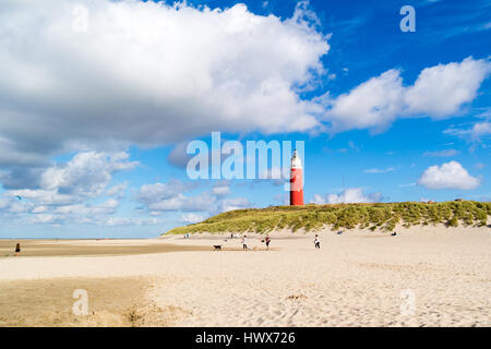 Beach with people and lighthouse of De Cocksdorp on island Texel, North Holland, Netherlands Stock Photo