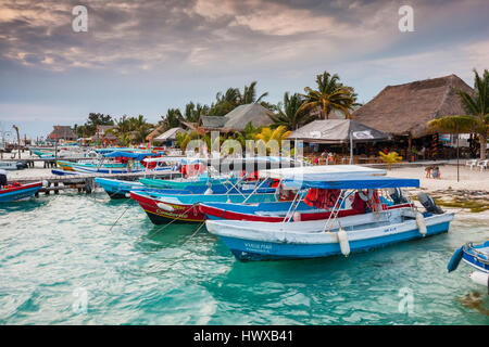 Cloudy sunset with colourful boats in dock on Isla Mujeres Stock Photo