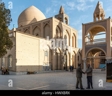 Men shaking hands in courtyard of Vank Armenian Cathedral, Isfahan, Iran Stock Photo