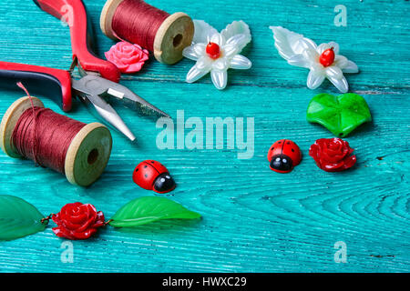 Handmade decoration in the form of leaves and flowers and tools Stock Photo