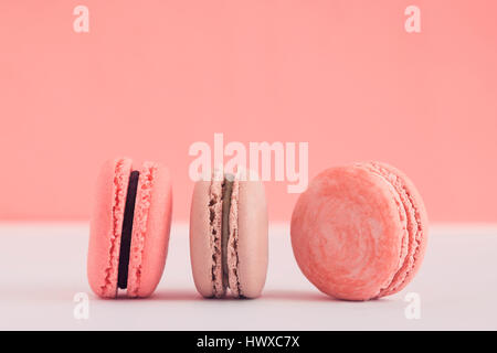 Assorted pink french  macaroons on a colored background. Copy space for text. Horizontal Stock Photo