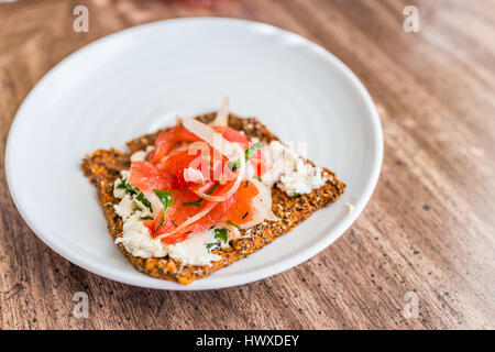 Macro closeup of healthy onion appetizer on chia flatbread toast and cheese Stock Photo