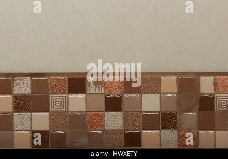Small brown tiles wall decoration. Ceramic creamy color tiles background Stock Photo