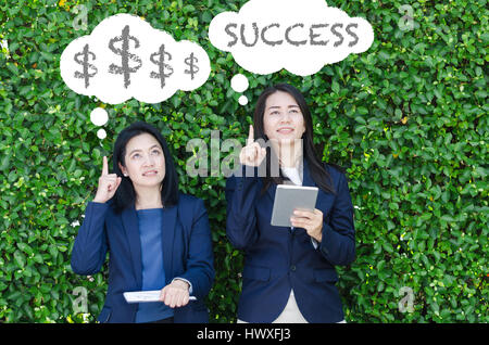 Leader business women concept. Two business women looking up and thinking about goals. Stock Photo