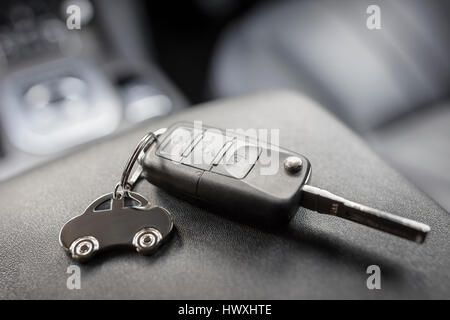 Car shape keyring and remote control key in vehicle interior Stock Photo