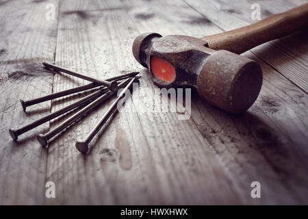 Hammer and nails on floorboards concept for construction, diy, tools and home improvement Stock Photo