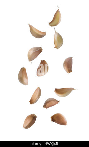 Falling garlic cloves isolated on white background. Stock Photo